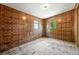 Bedroom featuring unique paneled walls, wood flooring, and two windows at 12 Marshall Pl, Longmont, CO 80504