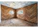 Bedroom showcasing wood paneled walls, wood flooring, and natural light at 12 Marshall Pl, Longmont, CO 80504