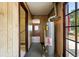 Hallway with wood paneling, hot water heater, and access to other rooms at 12 Marshall Pl, Longmont, CO 80504