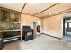 Kitchen featuring an oven, shelving, and wood paneled walls at 12 Marshall Pl, Longmont, CO 80504