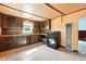 Kitchen featuring dark cabinets, tile flooring, and an oven at 12 Marshall Pl, Longmont, CO 80504