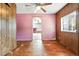This room features pink walls, wood panels, hardwood floors and arched doorway at 12 Marshall Pl, Longmont, CO 80504