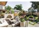 Inviting backyard featuring an outdoor seating area, fireplace, and lush landscaping at 1130 S Cook St, Denver, CO 80210
