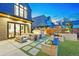 Beautiful backyard with an outdoor seating area, fireplace, and professionally landscaped greenery at 1130 S Cook St, Denver, CO 80210