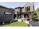 Modern backyard featuring multiple outdoor living spaces and manicured lawn at 1130 S Cook St, Denver, CO 80210