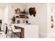 Basement bar with seating, shelving, and bar decorations at 1130 S Cook St, Denver, CO 80210