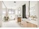 Modern bathroom features double sinks, quartz counters, sleek fixtures, and natural light at 1130 S Cook St, Denver, CO 80210