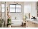 Serene bathroom with soaking tub, quartz counters, and modern fixtures at 1130 S Cook St, Denver, CO 80210