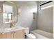 Tastefully decorated bathroom with accent tiling, a modern vanity, gold fixtures, and a soaking tub at 1130 S Cook St, Denver, CO 80210