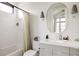 Modern bathroom featuring white tile, updated vanity, and stylish fixtures at 1130 S Cook St, Denver, CO 80210