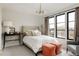 Well-lit bedroom boasts large windows and stylish decor for a cozy atmosphere at 1130 S Cook St, Denver, CO 80210