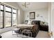Inviting bedroom with large windows, dark wood floors, and contemporary decor at 1130 S Cook St, Denver, CO 80210