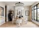 Elegant dining room features a modern chandelier, round table, and large windows, perfect for entertaining at 1130 S Cook St, Denver, CO 80210