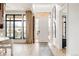 Inviting entryway with a stylish white door, black-framed windows, and natural light at 1130 S Cook St, Denver, CO 80210
