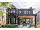 Modern two-story home features a brick and wood exterior, large windows, and manicured landscaping at 1130 S Cook St, Denver, CO 80210