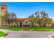 Beautiful building exterior with a striking tower, lush greenery, and a charming statue, creating a picturesque setting at 1130 S Cook St, Denver, CO 80210