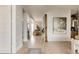 Bright foyer with hardwood floors, white walls, and a view into the open-concept living space at 1130 S Cook St, Denver, CO 80210