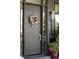 Stylish front door with a wreath and sleek design, complemented by modern hardware and house numbers at 1130 S Cook St, Denver, CO 80210