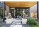 Inviting front porch with Asian statues, modern seating, and a stylish entryway at 1130 S Cook St, Denver, CO 80210