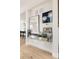 Refined hallway with mirrored shelf, decorative artwork, and modern finishes at 1130 S Cook St, Denver, CO 80210
