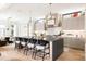 Modern kitchen with a large island, bar seating, and open layout to the living space at 1130 S Cook St, Denver, CO 80210