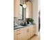 Modern kitchen with light wood cabinets, black hardware, and sleek countertops at 1130 S Cook St, Denver, CO 80210