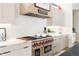 Gourmet kitchen featuring a professional-grade range, white countertops, and ample cabinet space at 1130 S Cook St, Denver, CO 80210