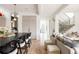 Open-concept living space featuring a large kitchen island and staircase with black metal railings at 1130 S Cook St, Denver, CO 80210