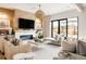 Bright living room featuring a fireplace, modern lighting, and access to outdoor space at 1130 S Cook St, Denver, CO 80210