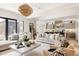 Open-concept living room with modern decor and seamless flow to the kitchen and outdoor area at 1130 S Cook St, Denver, CO 80210