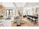 Open-concept living room featuring stylish seating, hardwood floors, and seamless flow to the kitchen at 1130 S Cook St, Denver, CO 80210