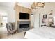 Bright main bedroom with modern fireplace, TV, and vaulted ceiling with modern lighting at 1130 S Cook St, Denver, CO 80210
