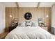 Beautifully staged main bedroom features wood-paneled wall and coordinated decor at 1130 S Cook St, Denver, CO 80210