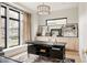 Modern office space with natural light, and a dark desk and cabinets at 1130 S Cook St, Denver, CO 80210