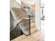 Modern staircase with light wood steps, black metal railings, and natural light at 1130 S Cook St, Denver, CO 80210