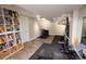 Spacious basement with fitness equipment, storage shelves and wood-look floors at 8229 Estes Ct, Arvada, CO 80005