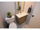Modern bathroom features a stylish vanity, toilet, and hexagon tile flooring at 8229 Estes Ct, Arvada, CO 80005