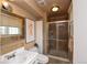 Updated bathroom featuring a shower, sleek vanity, and a decorative mirror at 8229 Estes Ct, Arvada, CO 80005
