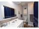 Bathroom featuring a white vanity, toilet, and bathtub with modern fixtures and stylish design at 8229 Estes Ct, Arvada, CO 80005