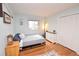 Inviting bedroom with hardwood floors, natural light, and closet at 8229 Estes Ct, Arvada, CO 80005