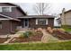 Charming home featuring a brick facade, well-manicured garden, and inviting front door at 8229 Estes Ct, Arvada, CO 80005