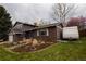 Charming home featuring a brick facade, well-manicured garden, and RV parking at 8229 Estes Ct, Arvada, CO 80005