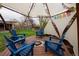Cozy gazebo with Adirondack chairs around a fire pit, perfect for outdoor relaxation and conversation at 8229 Estes Ct, Arvada, CO 80005