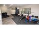 Spacious home gym with weightlifting equipment, a climbing wall, and mirrored walls at 8229 Estes Ct, Arvada, CO 80005