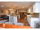 Open kitchen with granite countertops, island with wine rack and stainless appliances at 8229 Estes Ct, Arvada, CO 80005