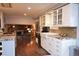 Modern kitchen with white cabinetry, granite countertops, stainless steel appliances, and hardwood floors at 8229 Estes Ct, Arvada, CO 80005