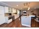 Modern kitchen with white cabinetry, granite countertops, stainless steel appliances, and hardwood floors at 8229 Estes Ct, Arvada, CO 80005