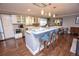 Modern kitchen with white cabinetry, granite countertops, stainless steel appliances, and hardwood floors at 8229 Estes Ct, Arvada, CO 80005