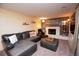 Comfortable living room with fireplace, mantel, leather sectional, and natural light from windows at 8229 Estes Ct, Arvada, CO 80005