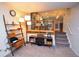 Cozy living room features a decorative shelf, modern lighting, and stairs to upper level at 8229 Estes Ct, Arvada, CO 80005